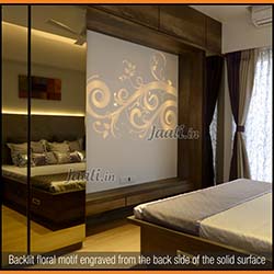 Backlit floral motif engraved from the back side of the solid surface